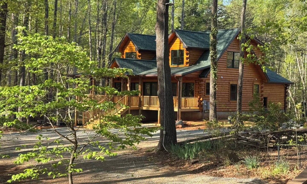 Union Hall Cabin | All Decked Out at Pine Haven — a brand-new lakefront log home on Smith Mountain Lake with a private hot tub, 50+ ft of wraparound deck, fire pit patio & easy lake access. Two full kitchens. One of 5 cabins on an 8-acre lakefront micro-resort.