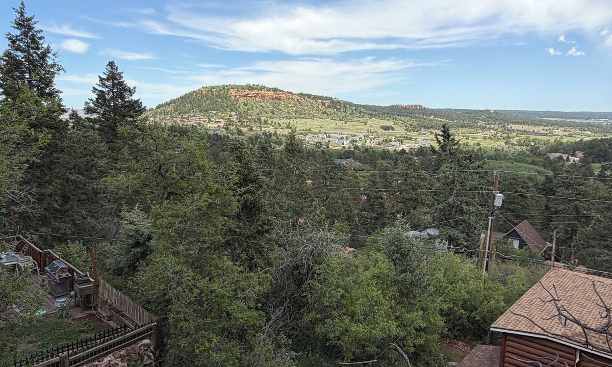 Palmer Lake House | Built in 1908 this historic cabin is full of original charm with a penthouse view. Step inside and you are immediately greeted by a full unobstructed view of Elephant Rock. Sleeping up to 9 people.