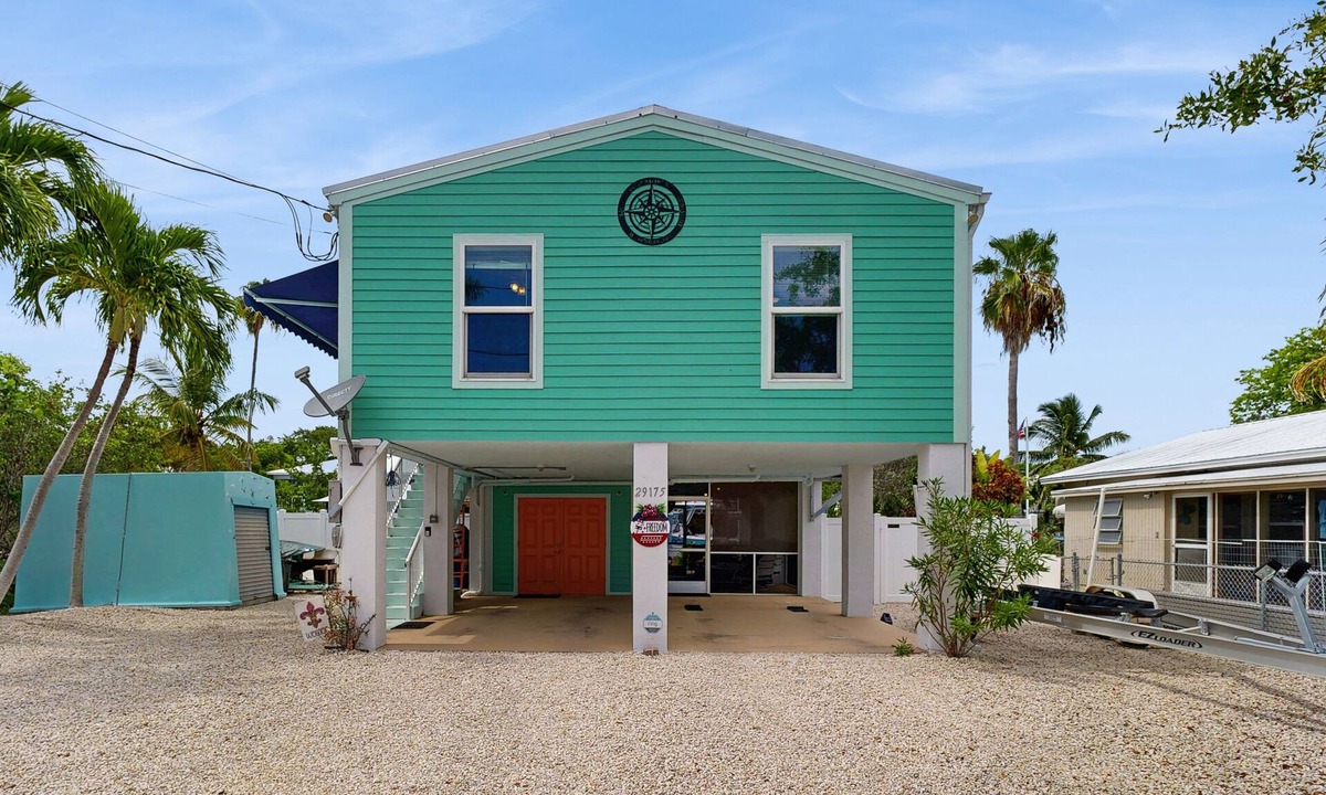Eden Pines House | Coastal canalfront home with swim spa, dock, kayaks, e-bikes & dog friendly