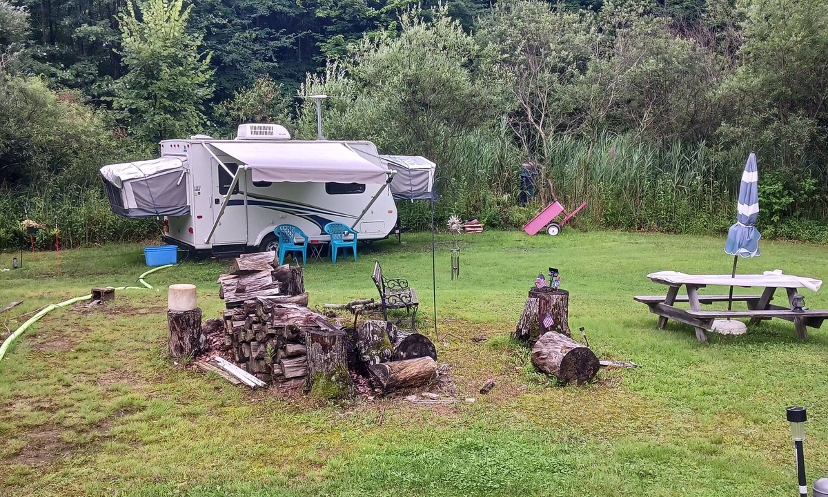Forestville RV Rental | Comfortable Camper a few miles off thruway and area attractions. Fire ring wood