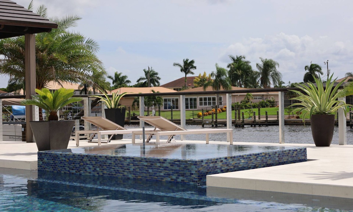 Caloosahatchee House | Custom Home with tile pool, boating dock and every comfort