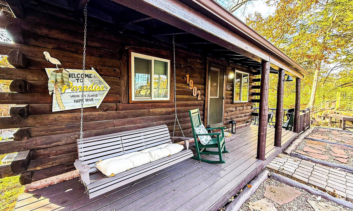 Lake Ozark House | Escape to Grandpa John’s Cabin in Four Seasons near Shady Gators & Camden on the Lake. This restored 2 bed, 2 bath log cabin features a king suite, bunk room, fireplace, coffee bar, deck, firepit, pet-friendly stay, and parking for cars & small boat.