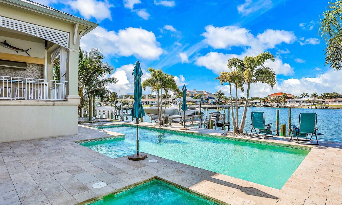 Island Estate House | Exquisite Clearwater Retreat w Heated Pool Game Room Outdoor kitchen and Kayaks