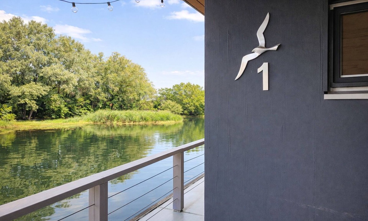 Laasow House | Floatinghouse Möwe 1: Lake view, terrace & fireplace on 116 sqm