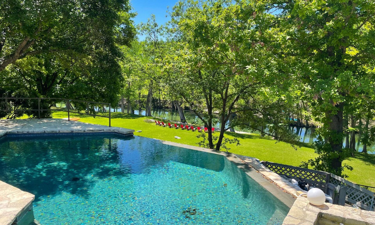 Hunt House | Inviting waterfront home with pool, patio, fireplace, W/D, & dog-friendly