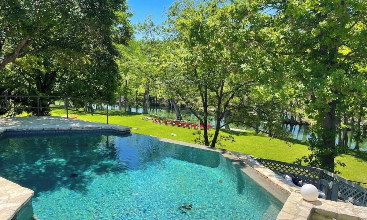 Hunt House | Inviting waterfront home with pool, patio, fireplace, W/D, & dog-friendly