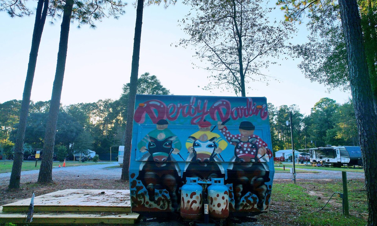 Milton RV Rental | KY Derby-themed glamper nestled in a beautiful treed area of the park. Sleeps 2-3, futon + drop-down table for 2nd bed. Staying here entitles our guests to access all of the park's amenities like the sparkling pool and spa with waterfall and cave gro