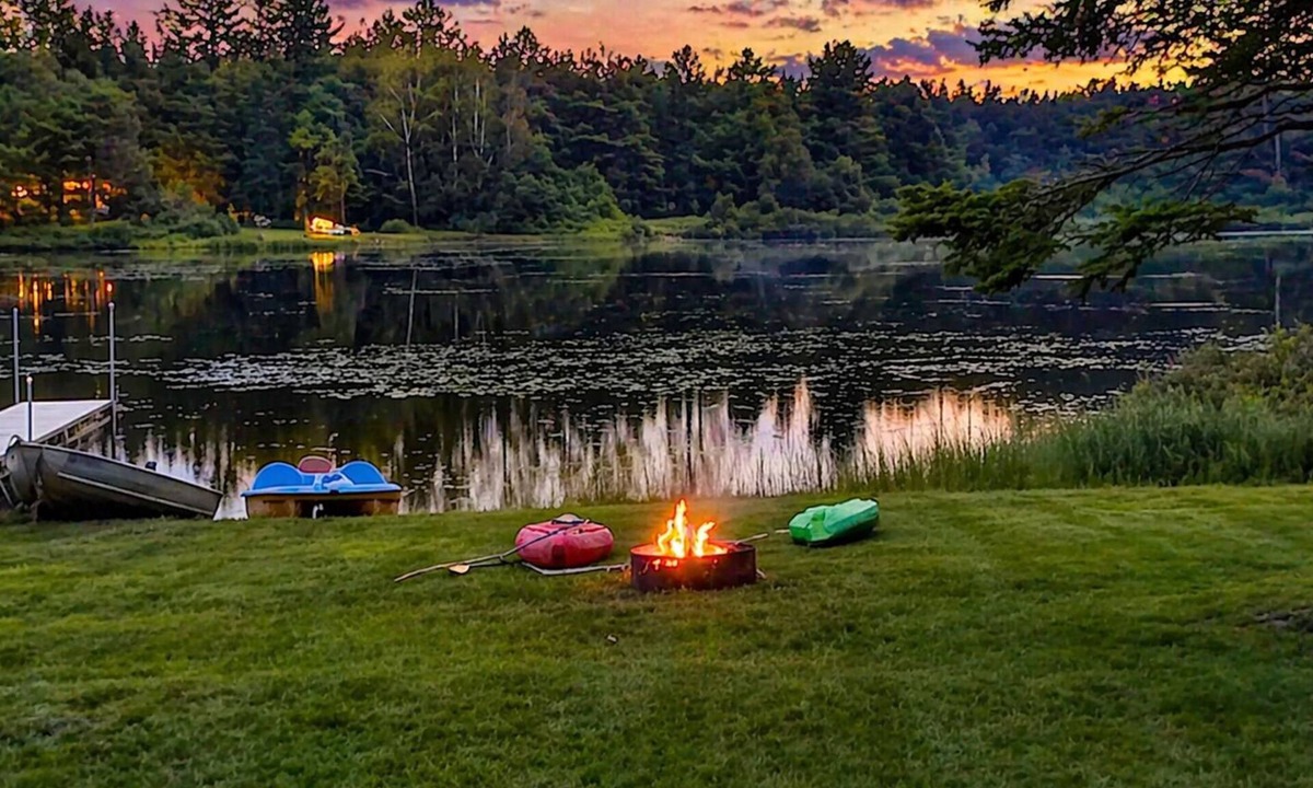 Wetmore Cottage | Lakefront, covered deck, huge backyard with grill, swimming, boat & kayaks!