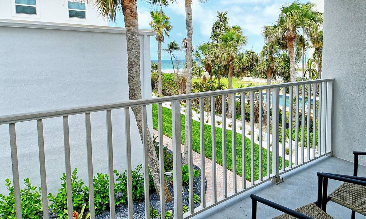 Longboat Key Apartment | LaPlaya 202E-Catch the gentle Gulf breezes on your private balcony beneath the swaying palms.
