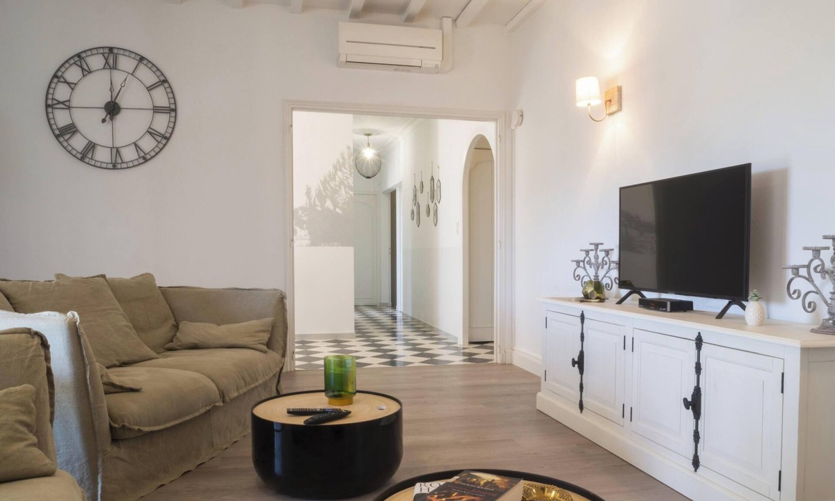 Paradou House | Mas Provençal first floor living room with fireplace and veranda overlooking Alpilles- Vallée des Baux