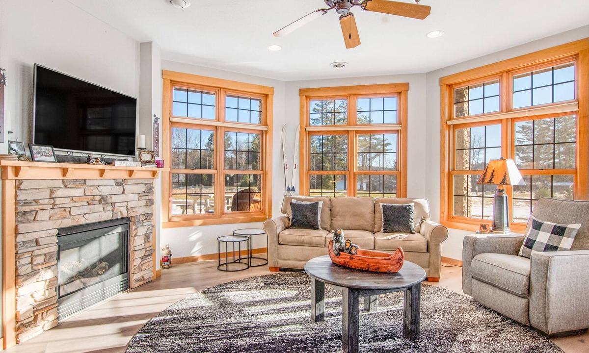 Three Lakes Condo | Modern lakefront condo with grill, W/D, gas fireplace, indoor pool, & hot tubs