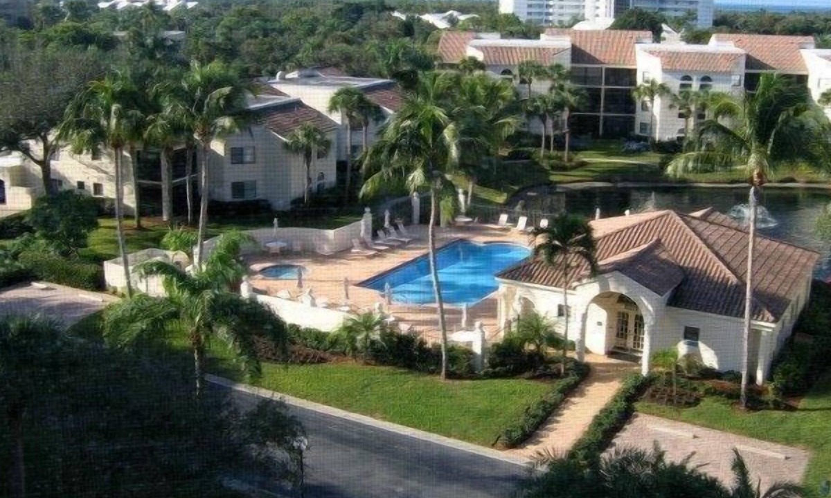 Pelican Bay Condo | OUTSTANDING LOCATION. End Unit Top Floor Condo near Beach, favored Pelican Bay