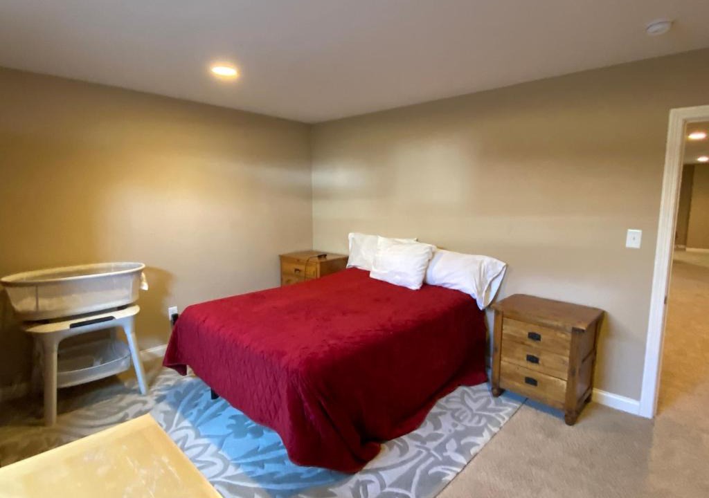 Maxwell House | Private basement bedroom with private bathroom, kitchen, and living room with large screen television