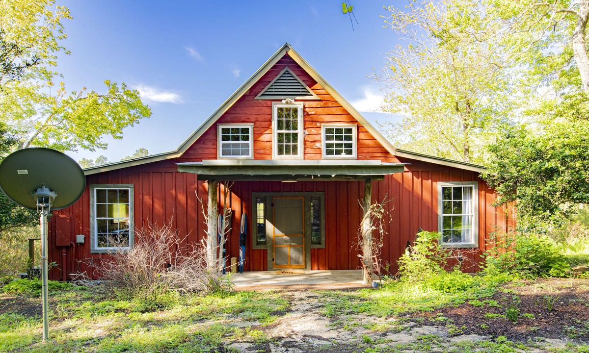 Fairhope Cabin | Private cabin built over a lake with a large breezy screened-in porch.