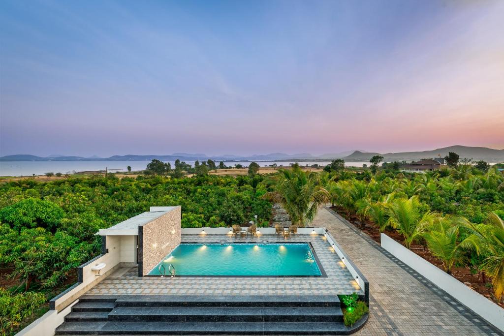 Nashik Villa | SaffronStays Mango Lakeview Villa - 3BR pool villa amid mango farms with Gangapur Dam views, deck & games