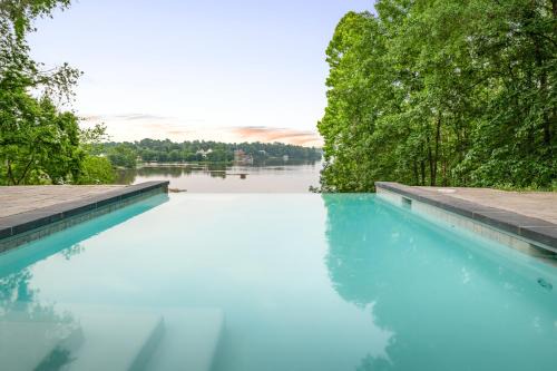 Louisa House | Secluded 3 Acre 5 BR Resort with Heated Private Lakeview Saltwater Infinity Pool, Hot Tub, Boat House, Sauna, and Game Room