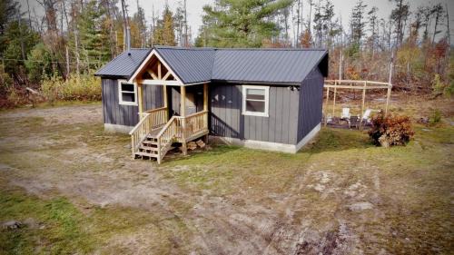 Idlewild House | Secluded Rustic Cabin with Hot Tub Near Pere Marquette River in Big Rapids, Michigan
