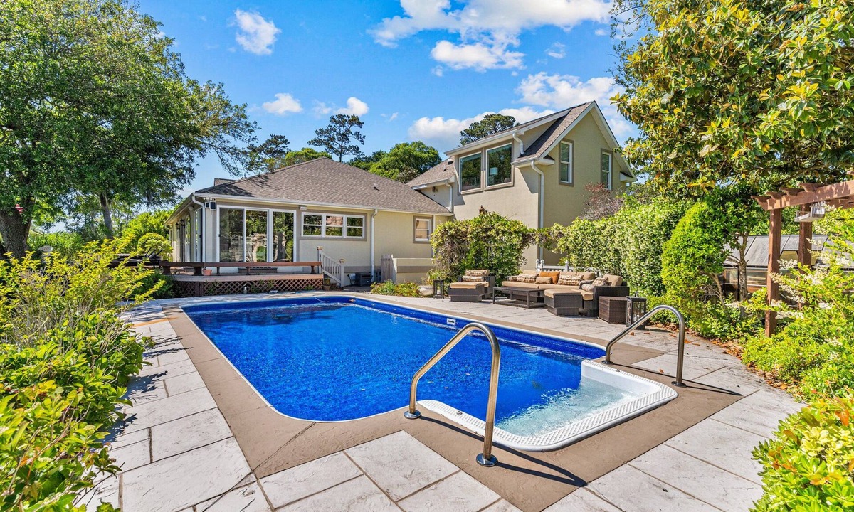 Sea Trail House | Shining Waters: Gorgeous waterfront home with private hot tub, pool, views, deck, & fireplace