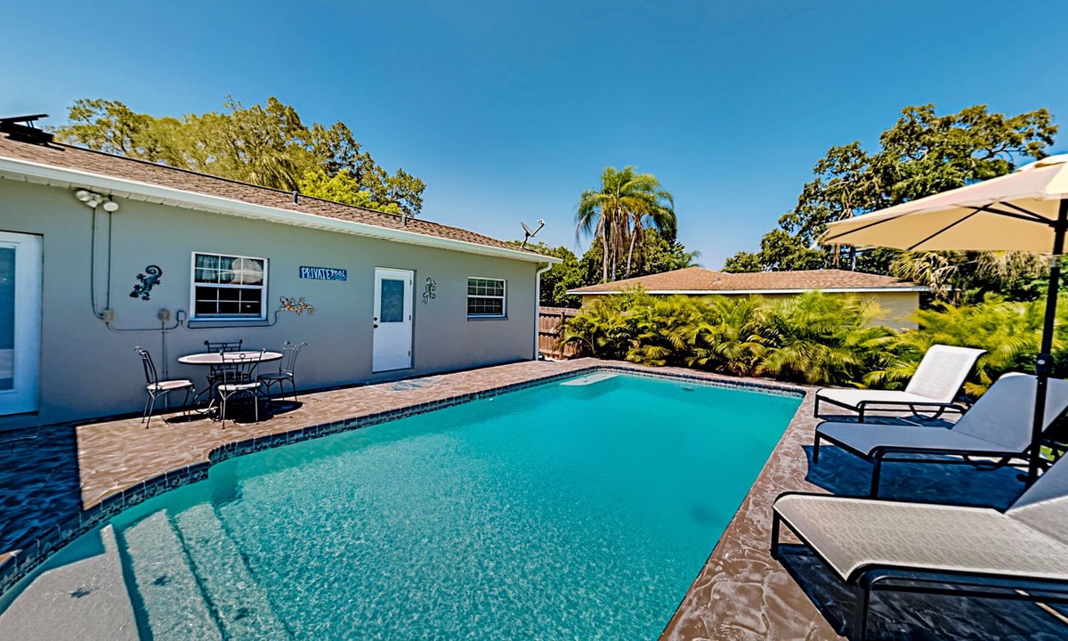 Harbor Bluffs House | Single-story home with outdoor dining, firepit, home office & laundry room