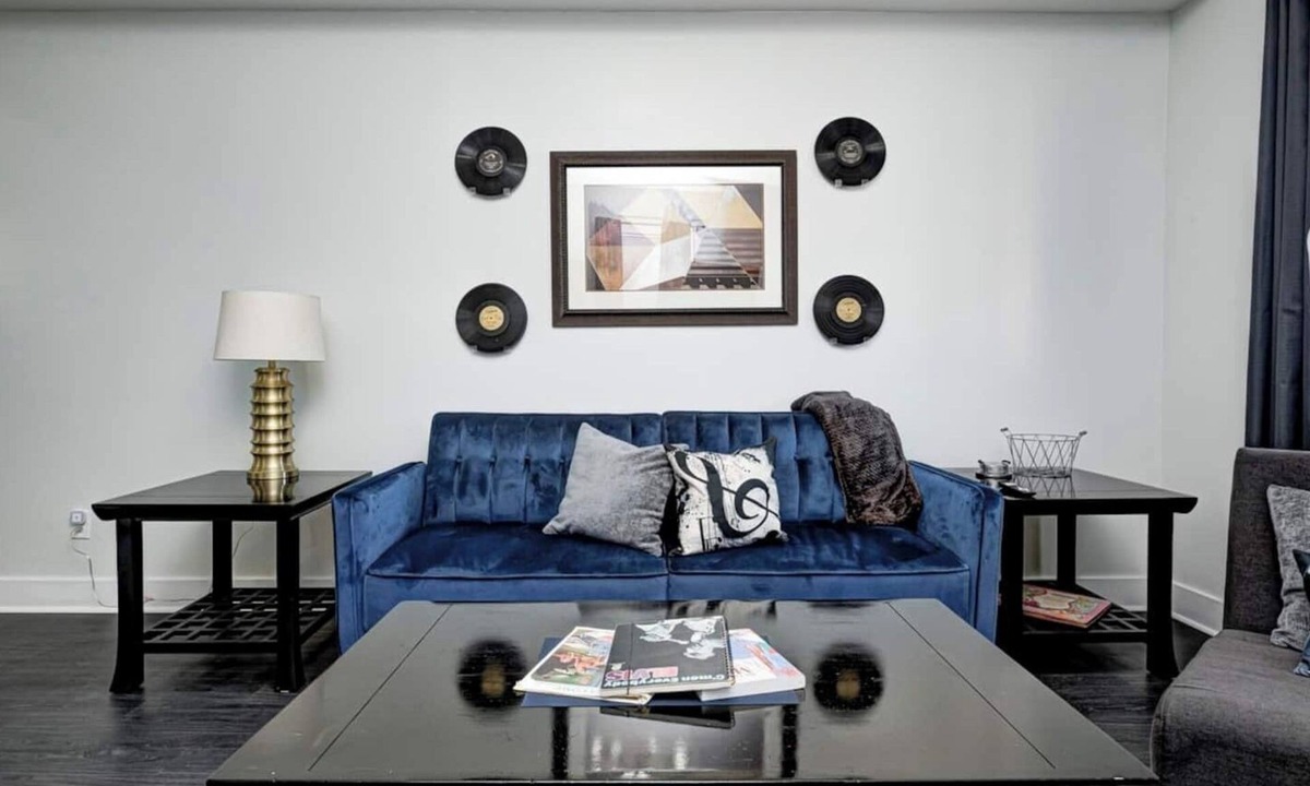 Fountain Square House | Sleeps 6 comfortably: 3 stylish bedrooms with plush bedding and blackout curtains. Music-themed decor: curated vinyls, vintage instruments, and artwork. This short-term rental features bold décor, modern amenities, and walkable access to