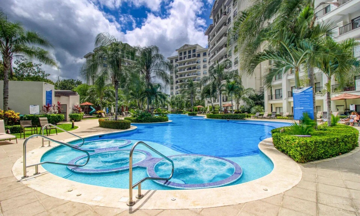 Jaco Condo | Stay in the heart of Jacó — steps from the beach, restaurants, nightlife, and bus stops. Enjoy 24/7 security, parking, a shared pool, and jacuzzi.