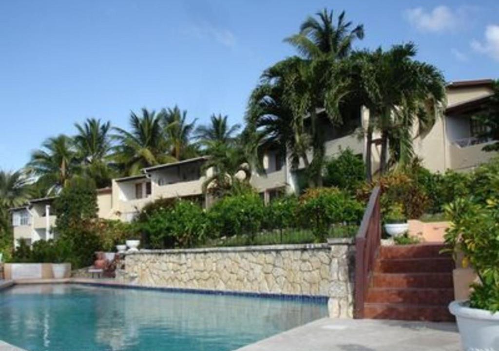 Dickenson Bay Apartment | Swimming Pool- Balcony Veranda- Sea & Sunset Views