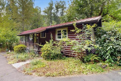 Molalla House | Tranquil landscape with riverside firepit gas grill gas fireplace and deck