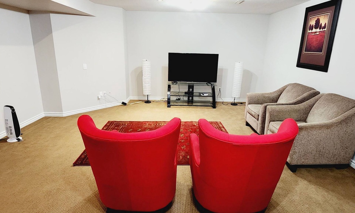 Airdrie House | Unique full basement suite with spacious living room.
