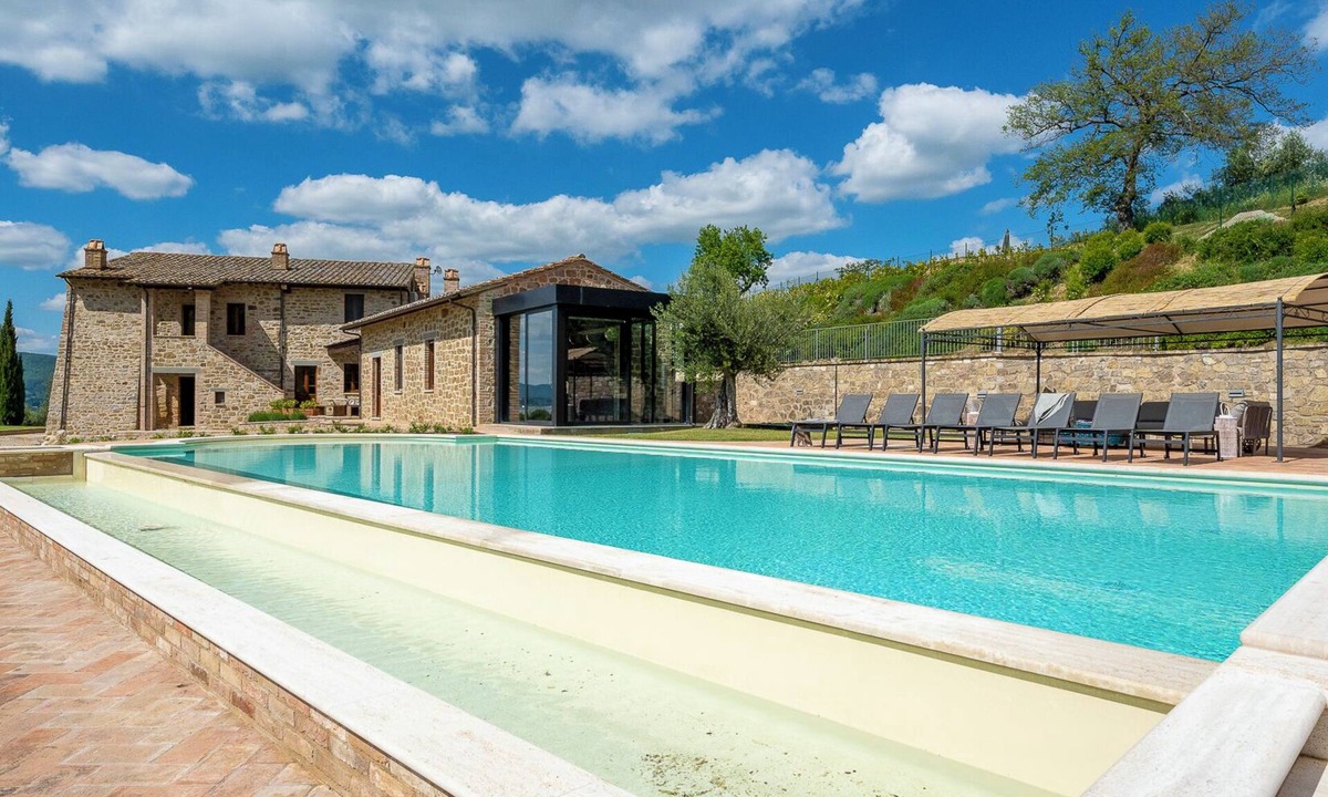 Torricella Villa | Villa Lago is set against a hillside of luscious greenery olive groves