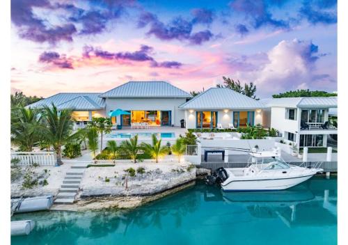 Caicos Islands Villa | Wakesurf Villa Waterfront Retreat with Dock Kayaks and Pool