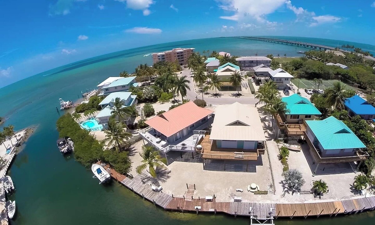 Marathon House | Waterfront Remodeled Home w/Private 35’ Boat Dock - at the foot of the iconic 7-Mile Bridge. Cozy house, water views, outdoor entertaining, private XL hot tub, walk to Sunset Grill for pool. Perfect for fishing, boaters, divers & sunset lovers.