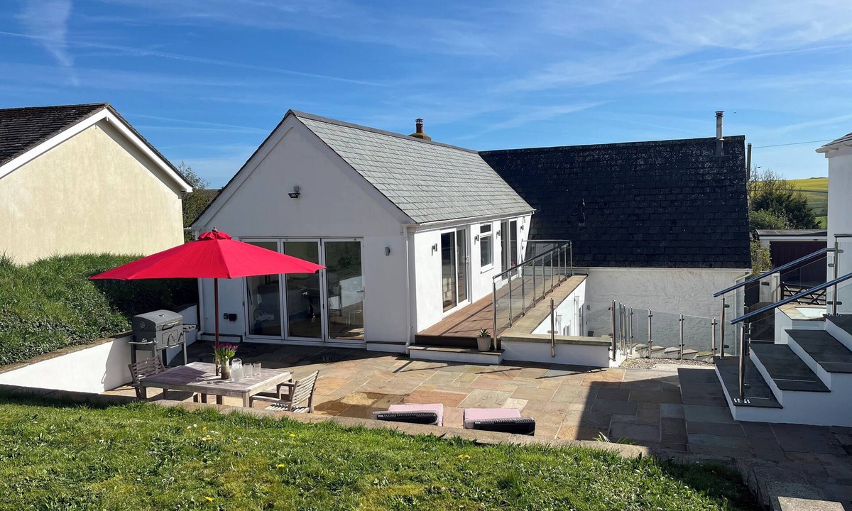 Malborough House | Windrush, Malborough. A spacious family home with a large patio and garden