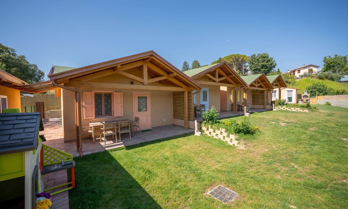 San Brizio Apartment | Wooden house with porch and garden