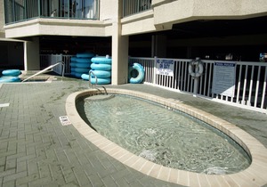 Oceanfront family-sized condo rental with lazy river, pool, and fitness center near Ocean Drive