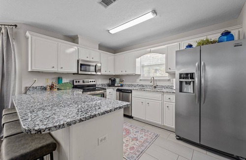 National Hills House | 3 bedroom, 2.5 bathroom patio home with an inground pool. The sleeping arrangements at this property include three queen beds and a futon located in the second living room.