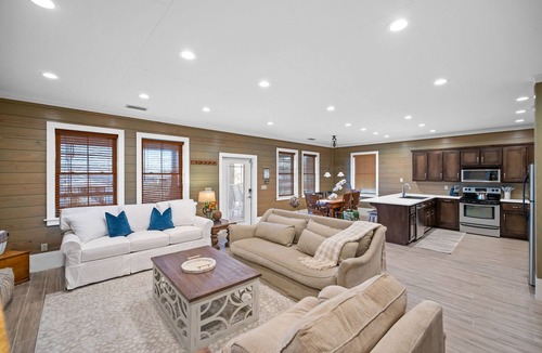 Alabama Gulf Coast House | A charming waterfront getaway on Mobile Bay featuring a private pier, cozy outdoor spaces, and beautiful bay views.