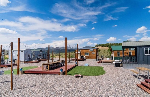 Meeker House | Adorable Tiny Home with two lofts. Both are accessible by ladder. One has a Queen mattress and the other has a Twin mattress. Home also contains a folding Full futon on main level. Sleeps: 4