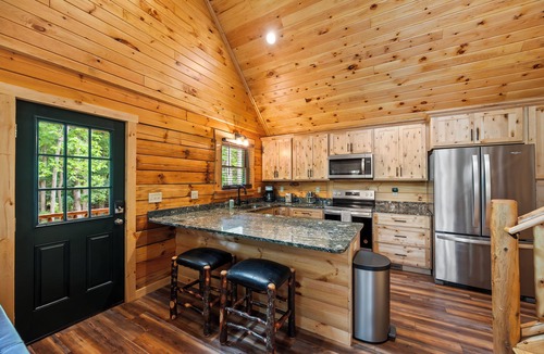 Union Hall Cabin | All Decked Out at Pine Haven — a brand-new lakefront log home on Smith Mountain Lake with a private hot tub, 50+ ft of wraparound deck, fire pit patio & easy lake access. Two full kitchens. One of 5 cabins on an 8-acre lakefront micro-resort.
