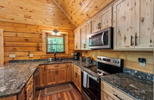 Union Hall Cabin | All Decked Out at Pine Haven — a brand-new lakefront log home on Smith Mountain Lake with a private hot tub, 50+ ft of wraparound deck, fire pit patio & easy lake access. Two full kitchens. One of 5 cabins on an 8-acre lakefront micro-resort.