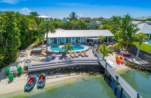 Stuart House | Aquatopia North: Riverfront beach house, w/dock, heated pool + hot tub & more!