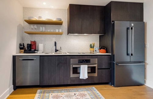 Rainey Street Historic District Apartment | Austin studio condo with WiFi, balcony, W/D, full kitchen, rooftop pool, & gym