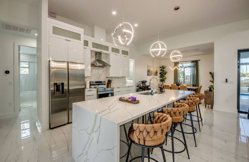 Pelican Villa | Awesome 4 BR/3 bath waterfront villa w. heated pool, hot tub, kayaks, fishing poles, bikes