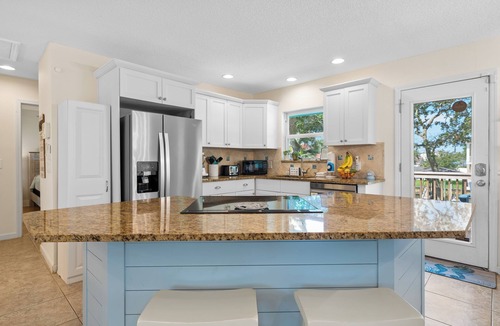 Butler Beach House | Backyard Paradise/Pool, Fire Pit, Games, & Kayaks on Canal Front near Beach