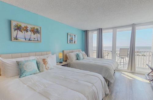 Treasure Island Condo | Beachfront Balcony ~ View of Treasure Island Beach ~ Heated Pool, Tiki Bar, BBQ Grills, Volleyball.