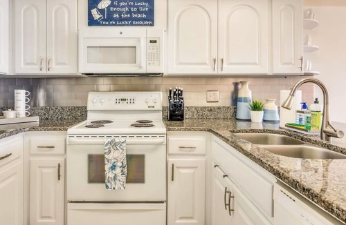 Indian Rocks Beach Apartment | Beachfront condo with a view of the water, a pool, a sundeck, a private balcony, and a washer and dryer