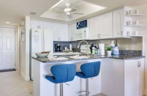 Indian Rocks Beach Apartment | Beachfront condo with a view of the water, a pool, a sundeck, a private balcony, and a washer and dryer