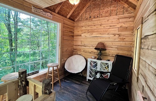 Kent County Cabin | Beautiful cedar treehouse that has wall-to-wall windows, forest and river view!