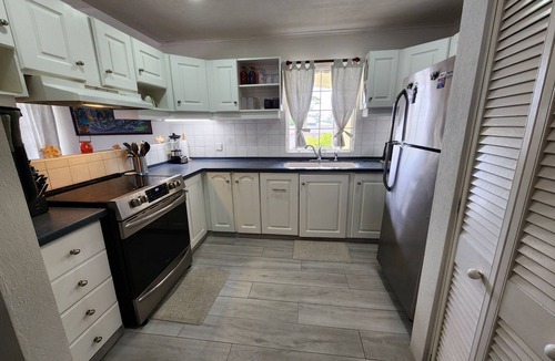 Marine Gardens Condo | Beautiful Condo with breezy Balcony Overlooking Pool & Garden – Steps to Beach