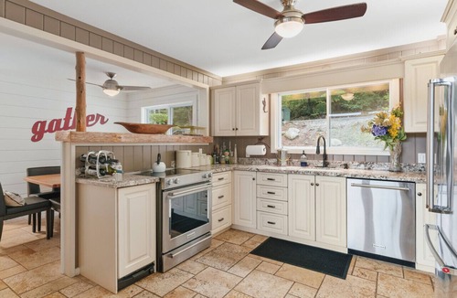 Windermere Cottage | Beautifully landscaped with a sandy beach, outdoor sauna, hot-tub and ample water toys.