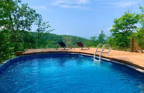 Morin Heights Ski Chalet | Blue Hill Pool spa game room mountain view